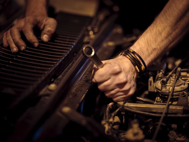 auto mechanic working on a client car