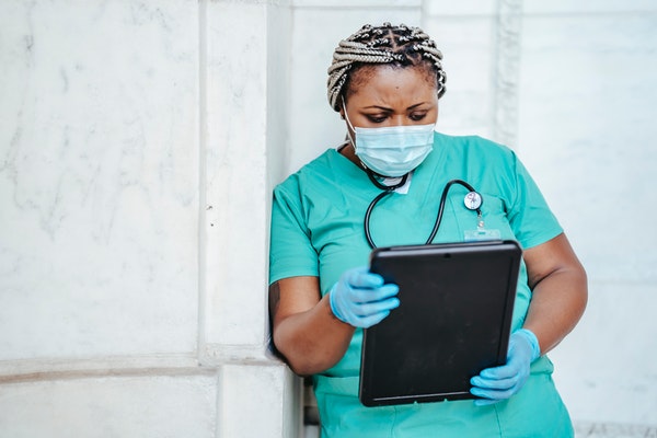 cna checking tablet for patient information