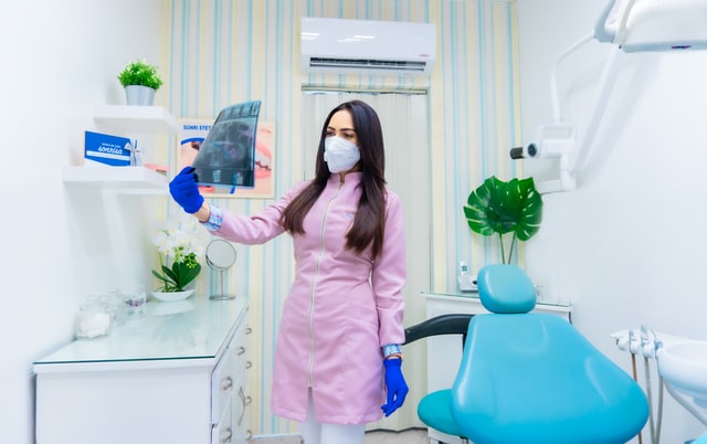 dental assistant holding teeth x ray shot