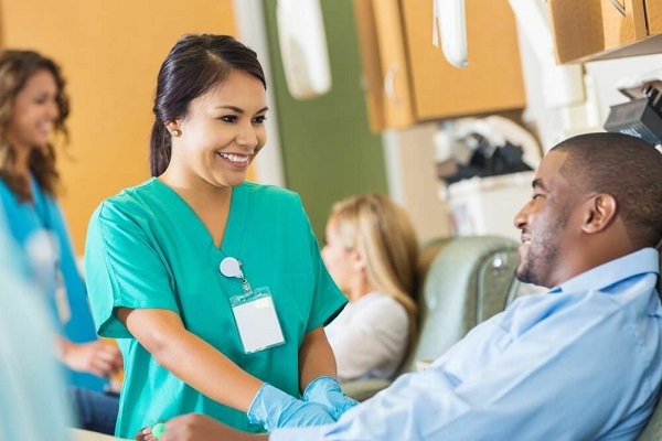 ekg technician helping patient