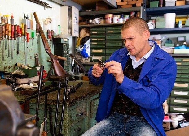 gunsmith fixing a rifle