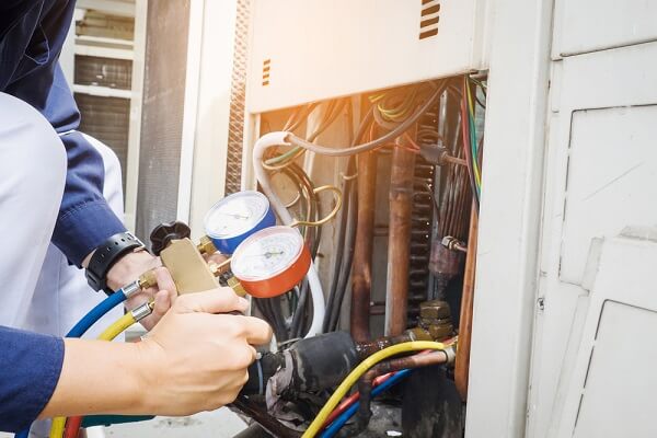 HVAC tech checking pressure