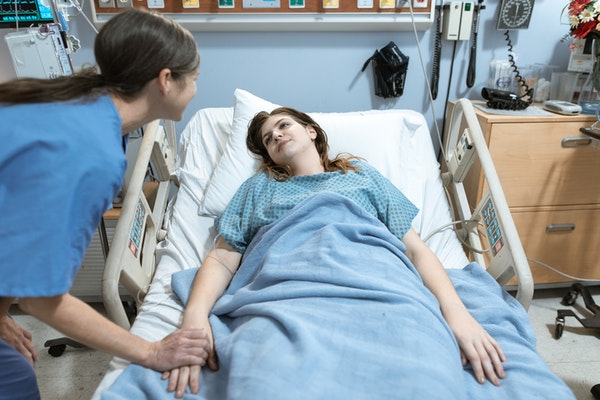 nurse assistant helping a patient