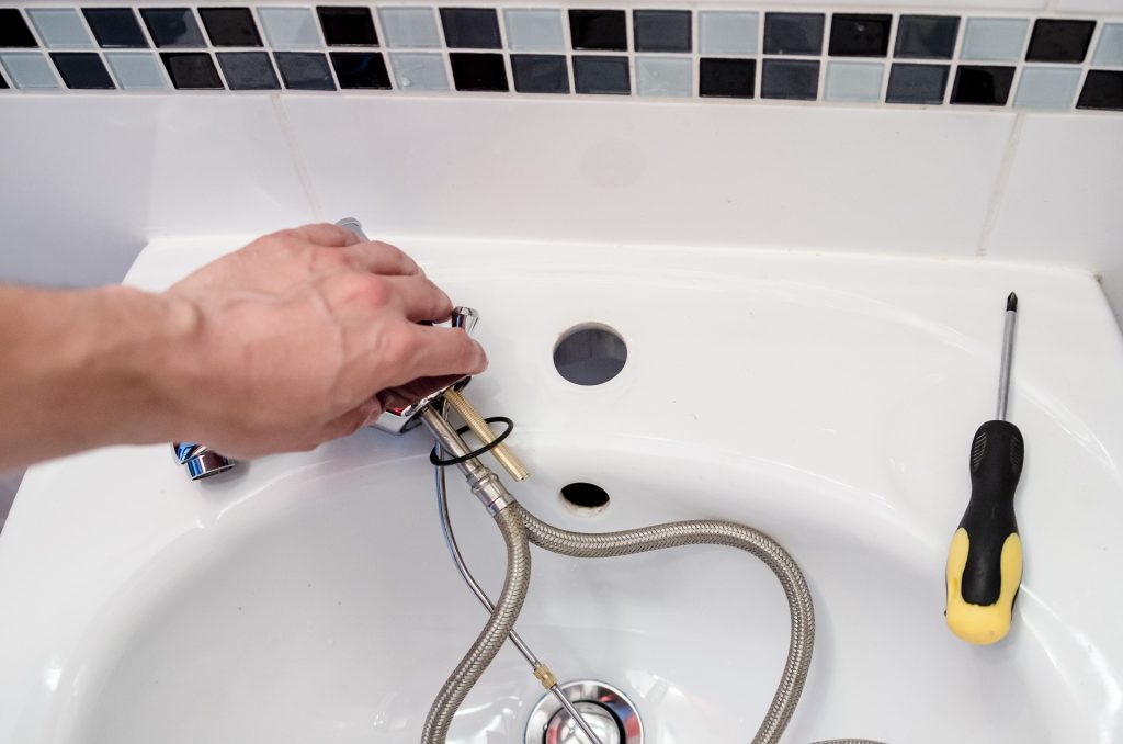 plumber replacing tap