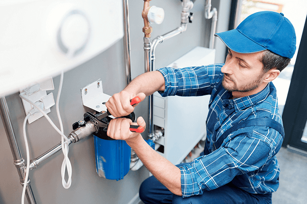 plumber installs filtration system
